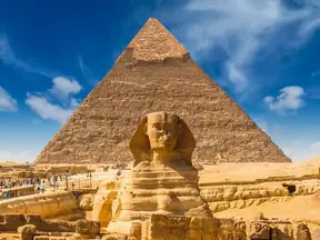 The Great Sphinx of Giza with a pyramid behind it